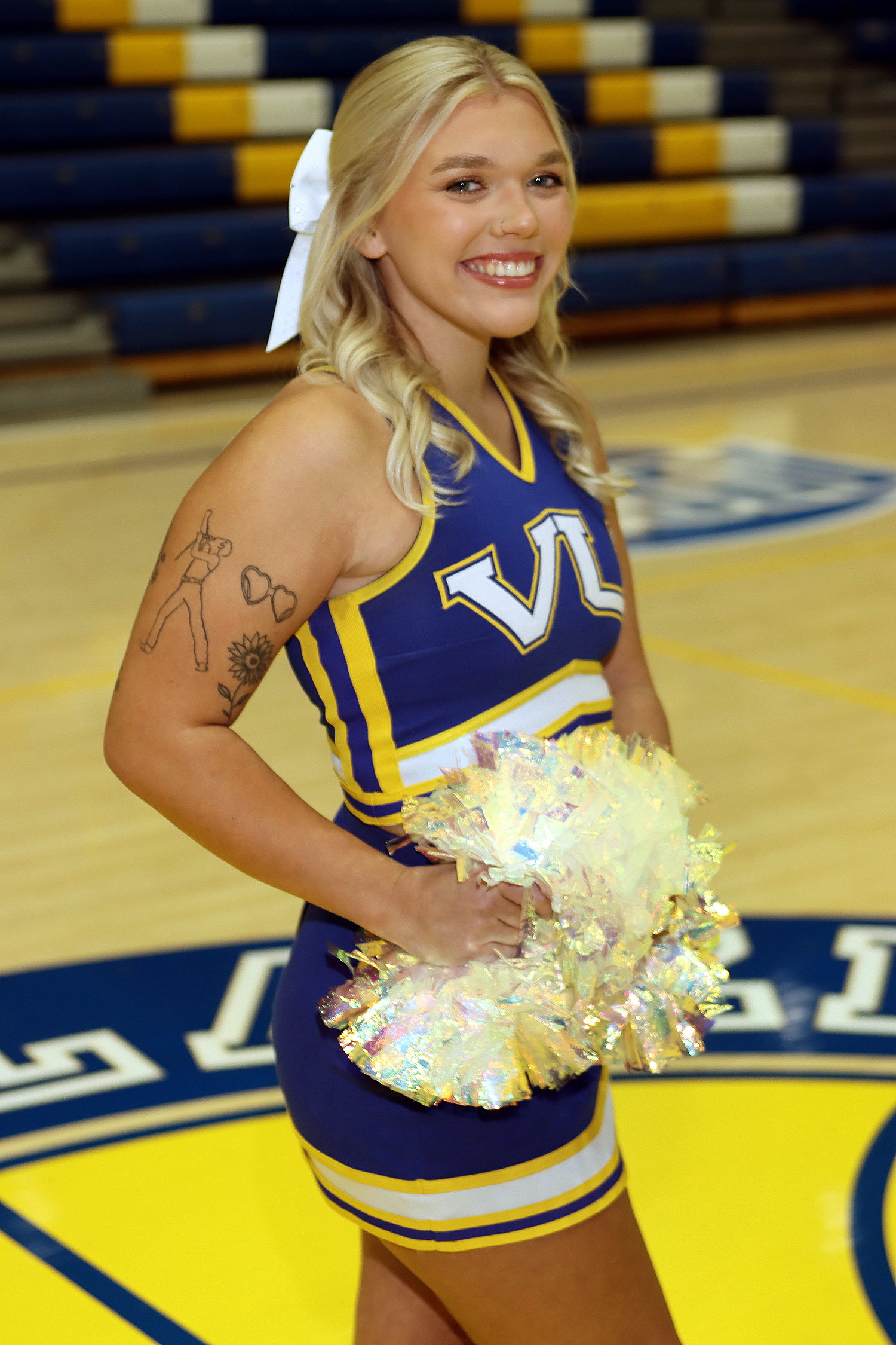 VU cheerleader Amelia Huffman wearing her cheer uniform and holding pom poms.